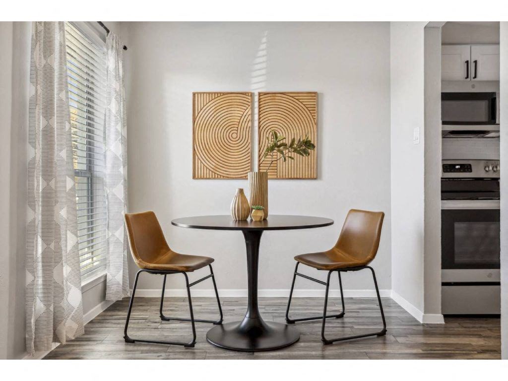 a dining room with a table and two chairs