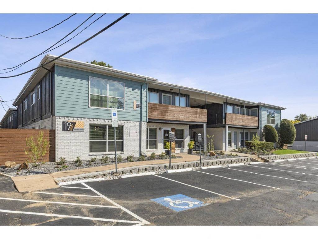 the exterior of a building with a parking lot