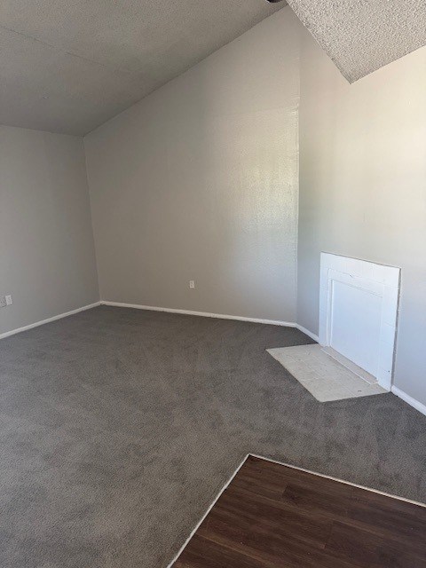 A room with a carpeted floor and a white door.
