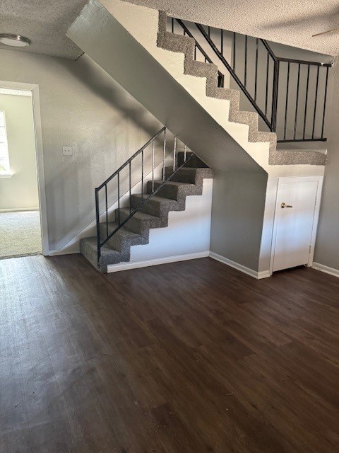 A wooden staircase with a metal railing.