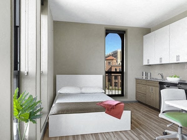 a white bedroom with a bed and a window