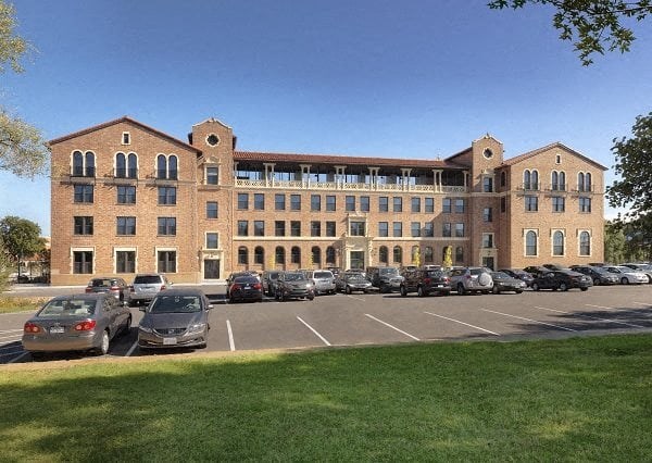 a parking lot with cars in front of a large building