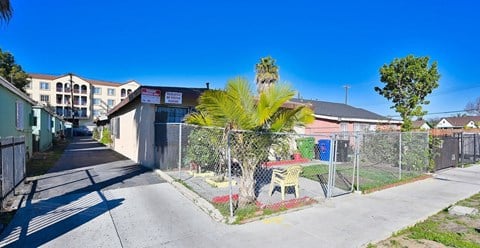 A sunny day in a residential area with a clear blue sky.