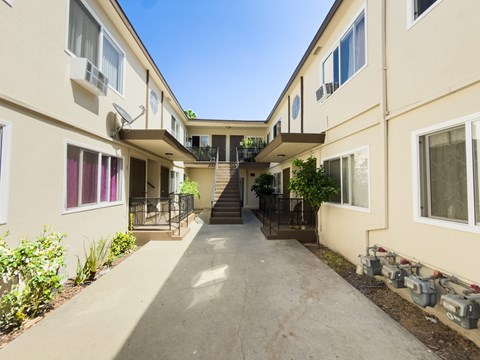 A sunny day at the apartment complex with a clear blue sky.