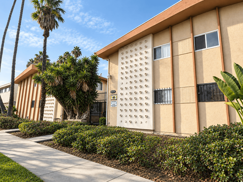 A building with a palm tree in front of it.