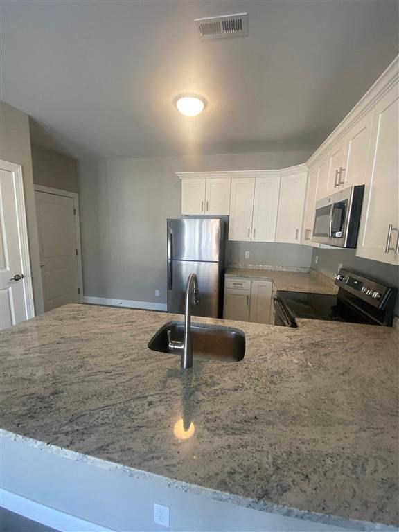 a kitchen with a sink and a refrigerator