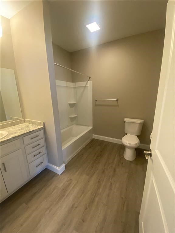 a bathroom with a toilet and a shower and a sink