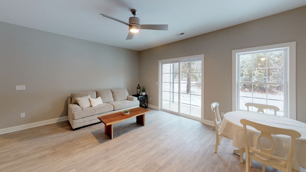 a living room and dining room with a couch and a table