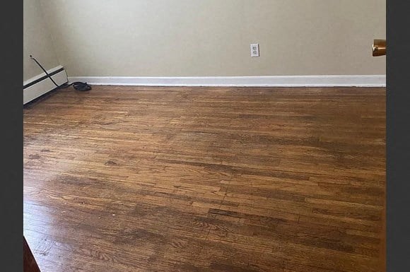 a living room with a wooden floor and a door