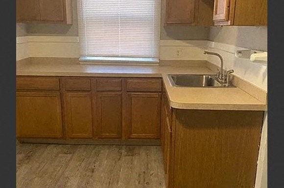 a kitchen with wooden cabinets and a sink