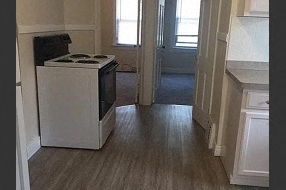 an empty kitchen with a stove in it