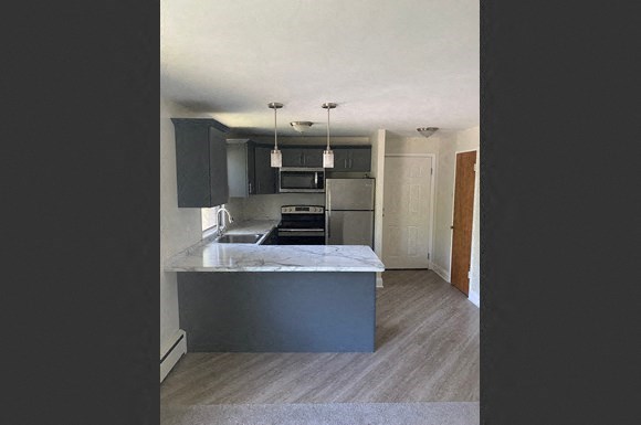 a kitchen with an island in the middle of it