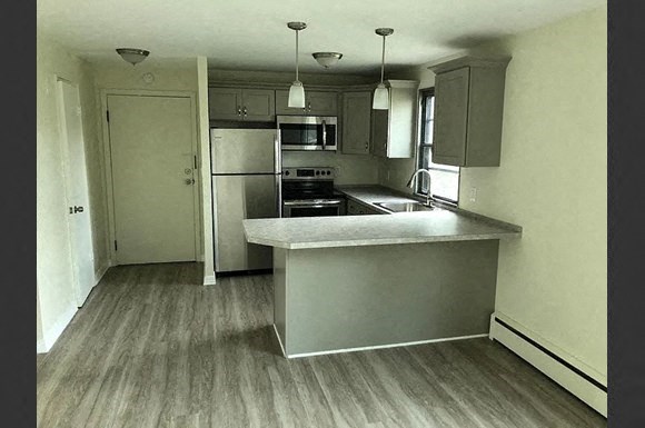 a kitchen with a counter top and a refrigerator
