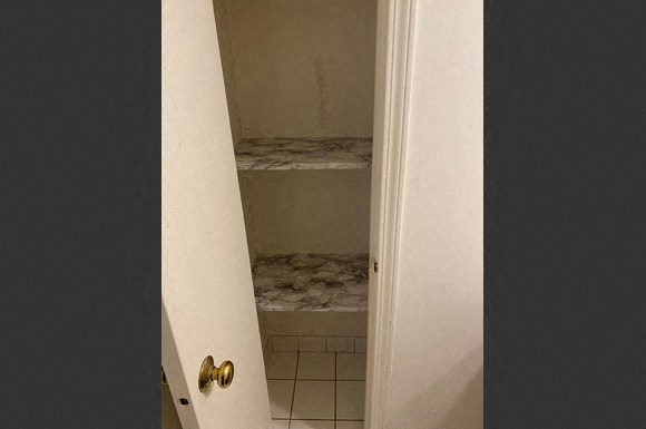an open door to a bathroom with a shower