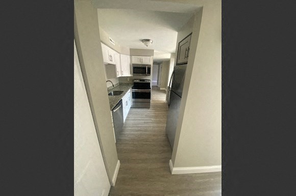 a view of a kitchen from a hallway