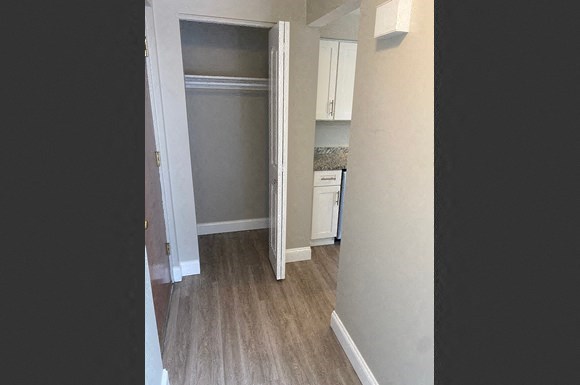 a hallway with a kitchen and a closet