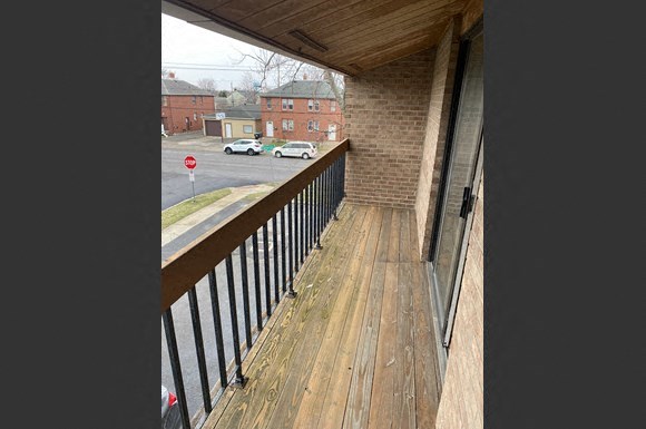 a balcony with a view of a street and buildings