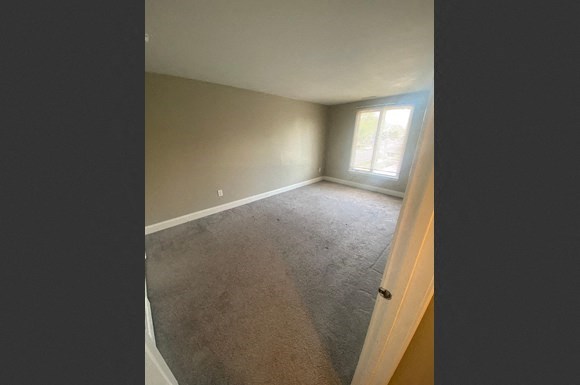 a empty room with a window and a door