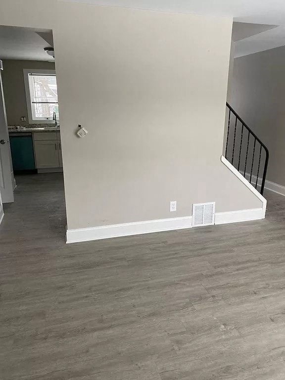an empty room with a staircase and a white wall