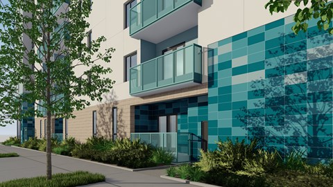 A modern building with a blue tiled wall and a tree in front.