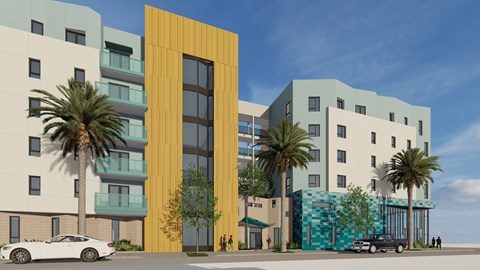A modern building with a yellow door stands out among other buildings.