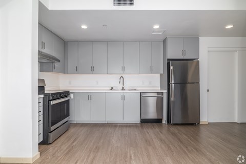 A modern kitchen with stainless steel appliances and white cabinets.