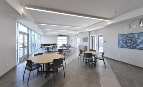 A conference room with a long table and chairs.