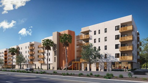 A modern apartment building with balconies and palm trees in front.