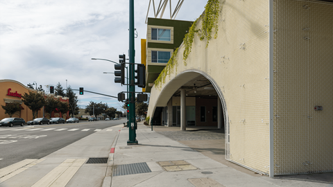 a building with an arch on the side of a street