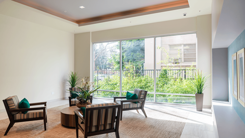 a living room with chairs and a table and a large window