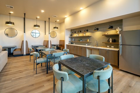 A modern dining area with a table and chairs.