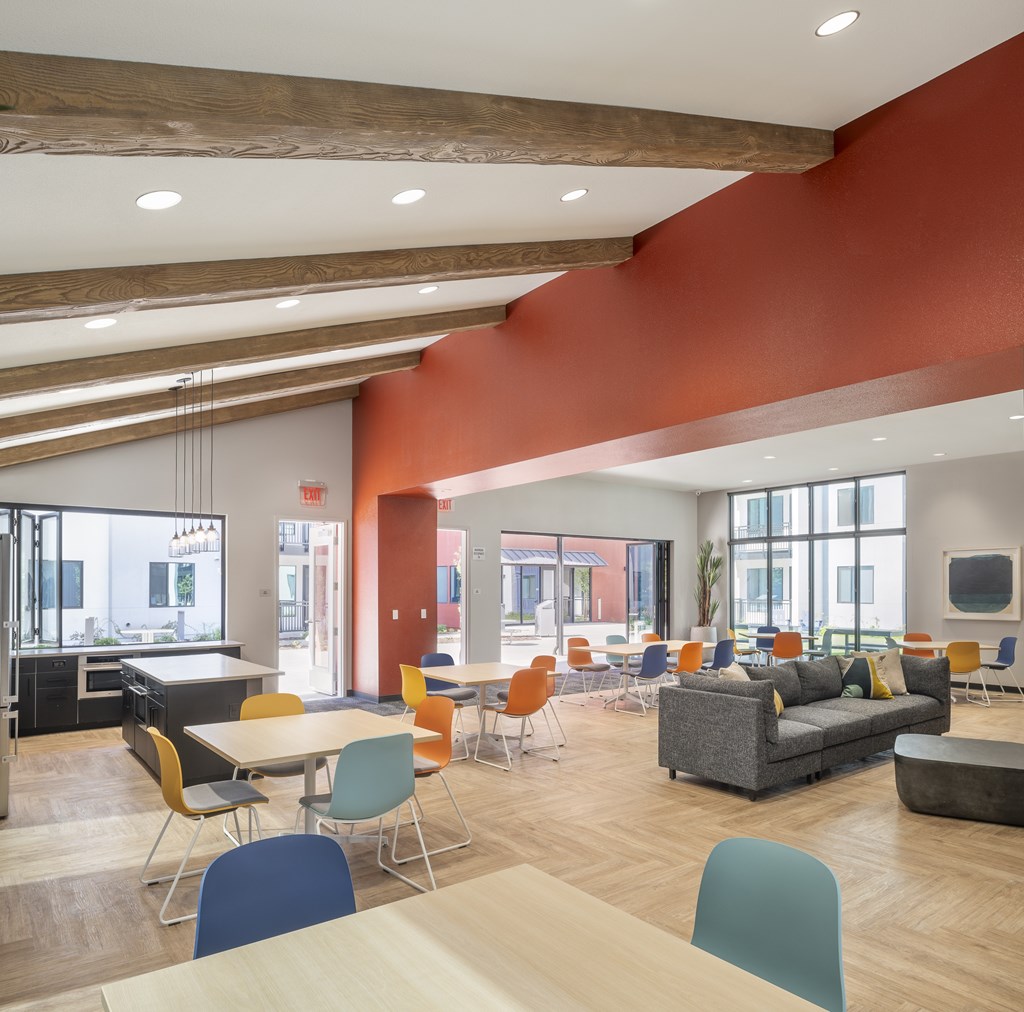 A modern open plan office space with a kitchen area.