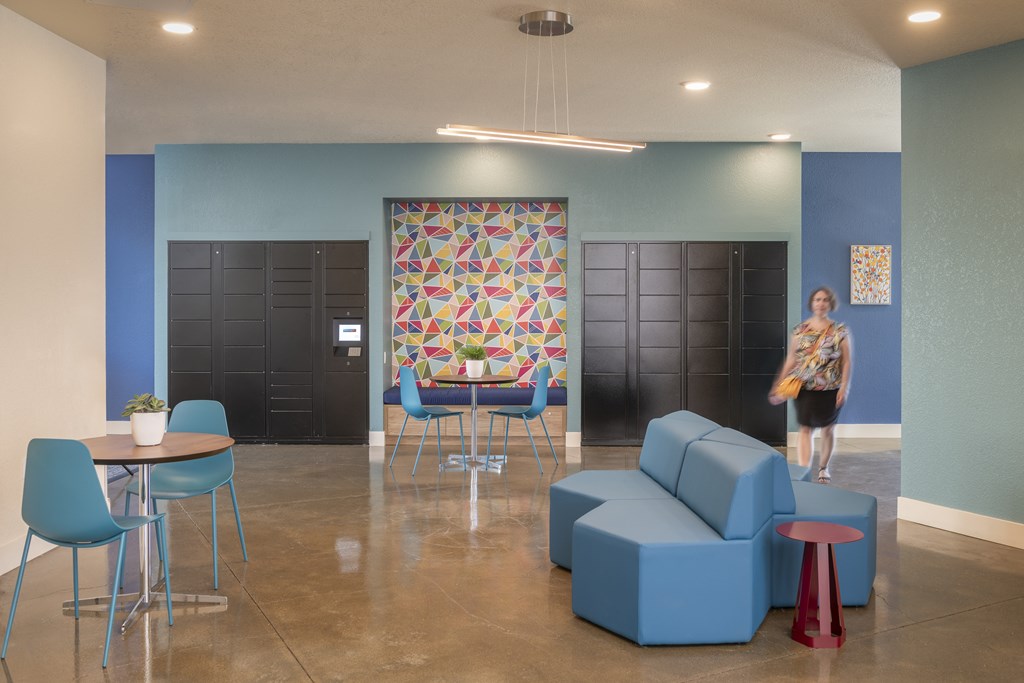 A woman walks through a blue and white room with a table and chairs.