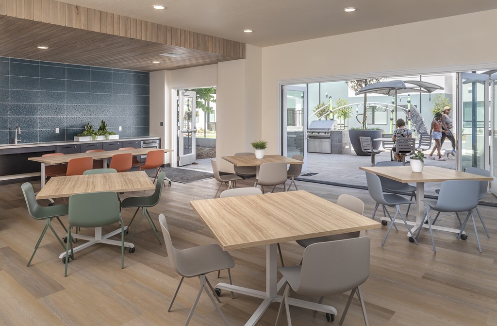 A modern dining area with wooden tables and chairs.