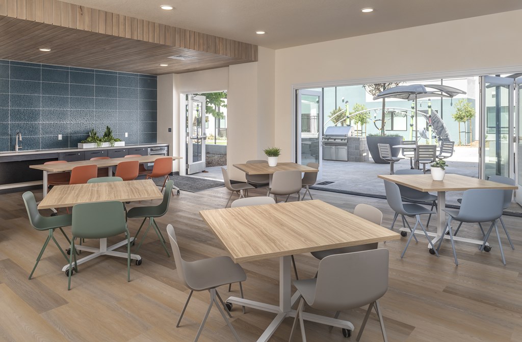 A modern dining area with wooden tables and chairs.