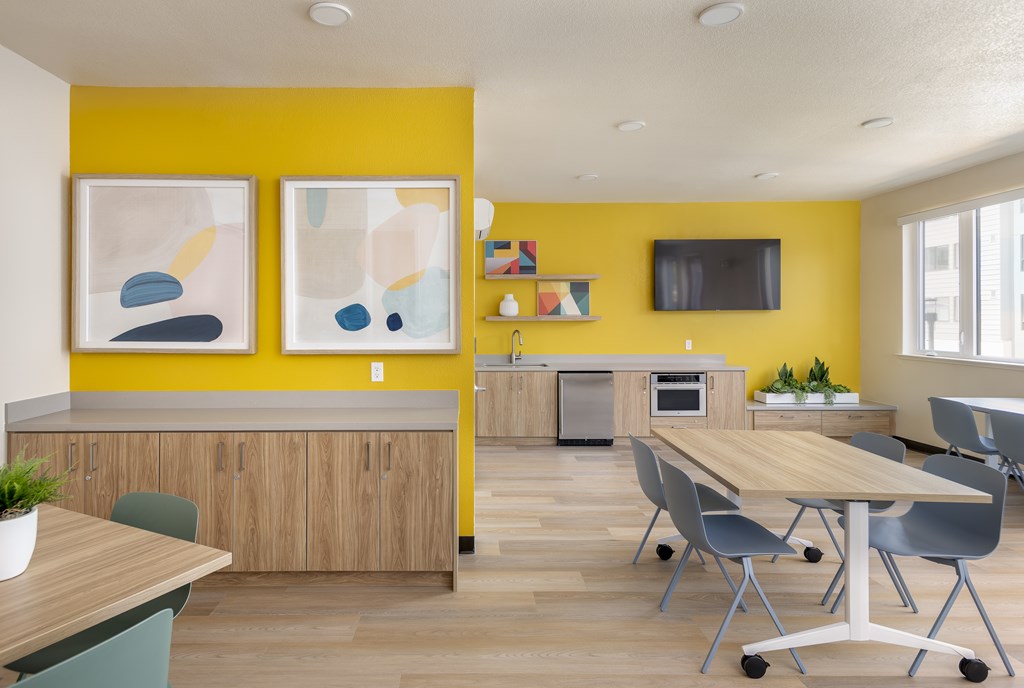 A modern kitchen with a wooden table and chairs.