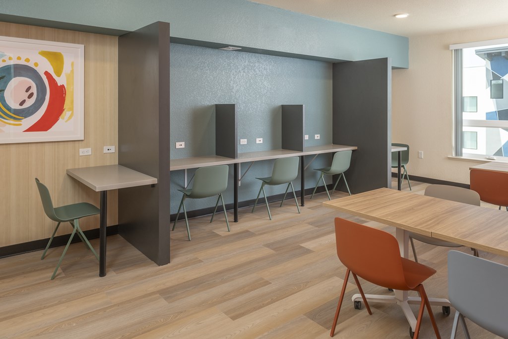 A conference room with a long table, chairs, and a speaker system.