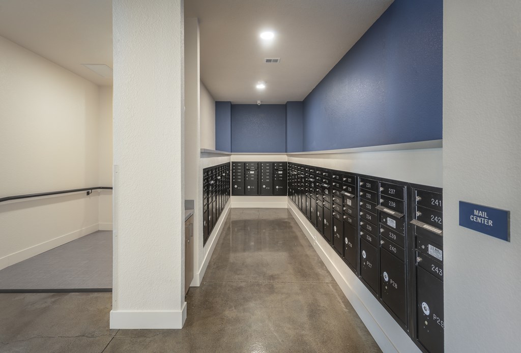 A hallway with a sign that says "Mail Center" on the wall.