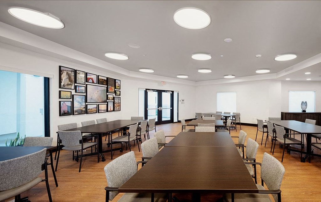 a large dining room with tables and chairs