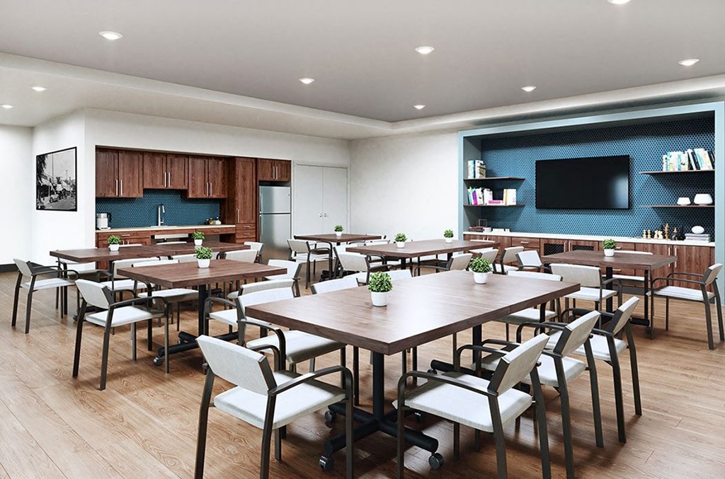 a conference room with tables and chairs and a television