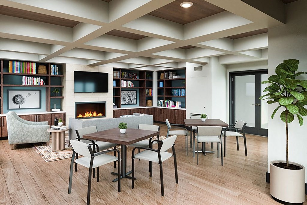 a living room with tables and chairs and a fireplace