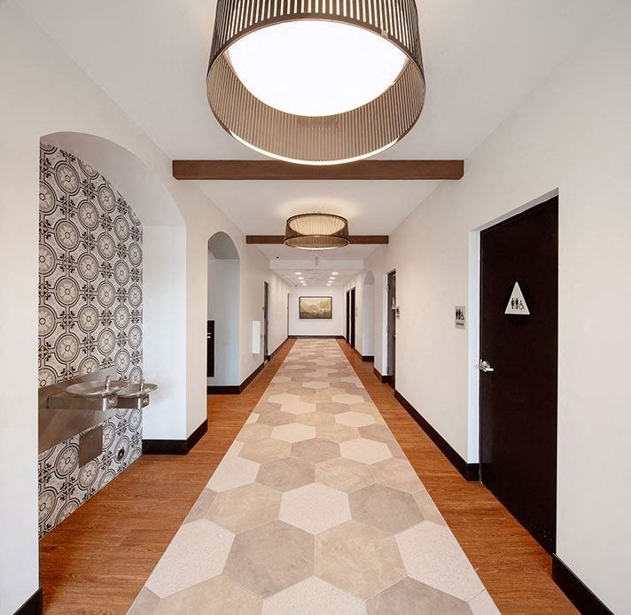 a long hallway with a wood floor and a ceiling light