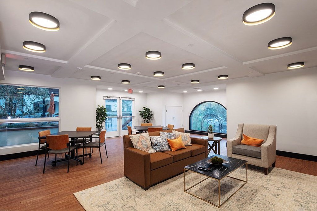 a living room with couches and chairs and a table
