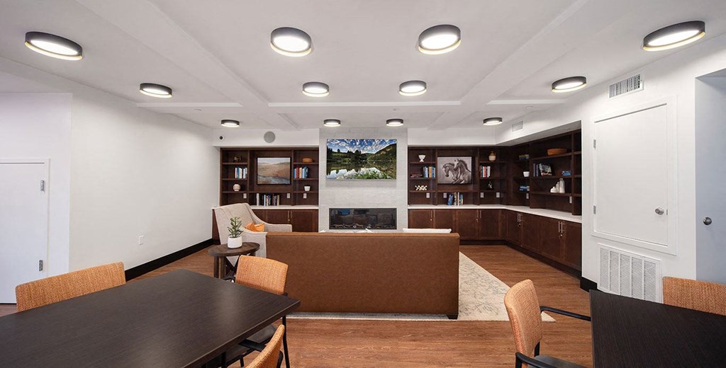 a living room with a table and a fireplace