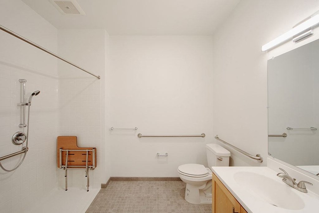 a bathroom with a toilet and a sink and a mirror
