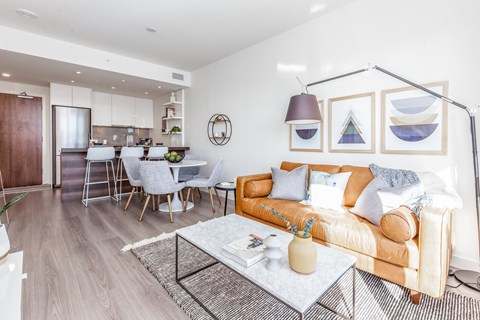 A living room with a white couch and a coffee table.