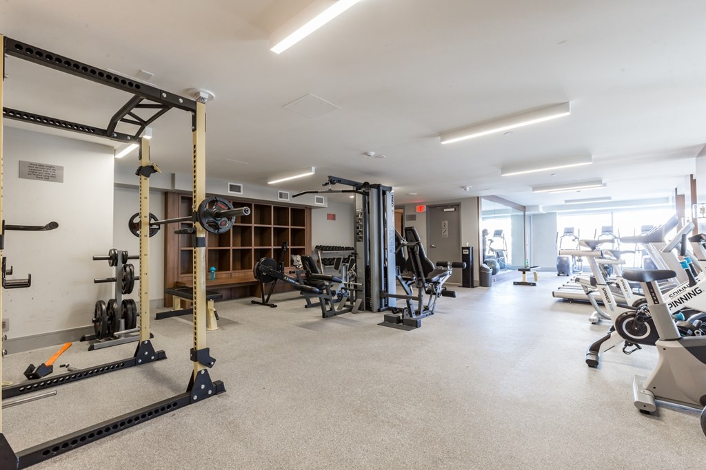A gym with a variety of equipment including weights and machines.
