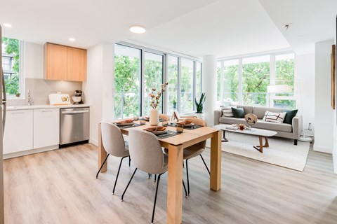 A modern dining room with a wooden table and chairs.