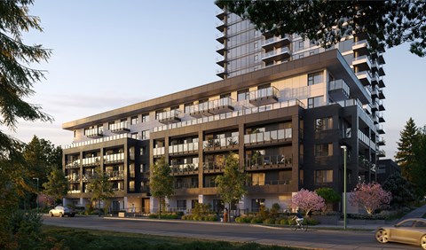 A modern apartment building with balconies and a car parked in front.