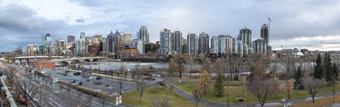 A city skyline with a bridge crossing a river.